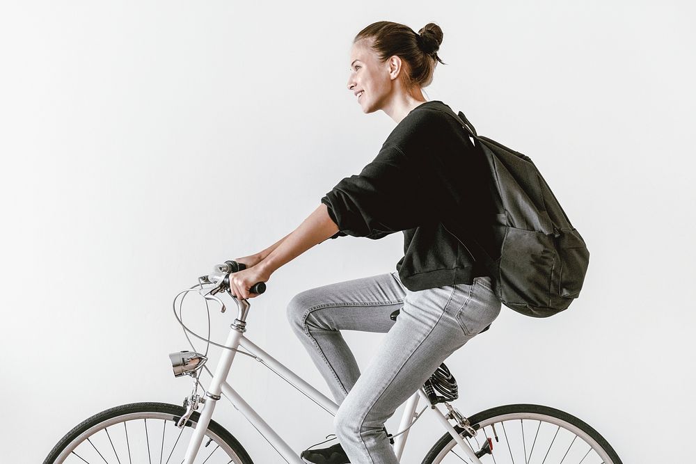 Woman riding bicycle to work, sustainable lifestyle HD photo