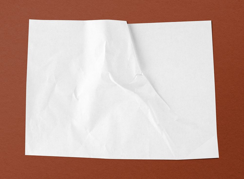 White crinkled paper on brown background