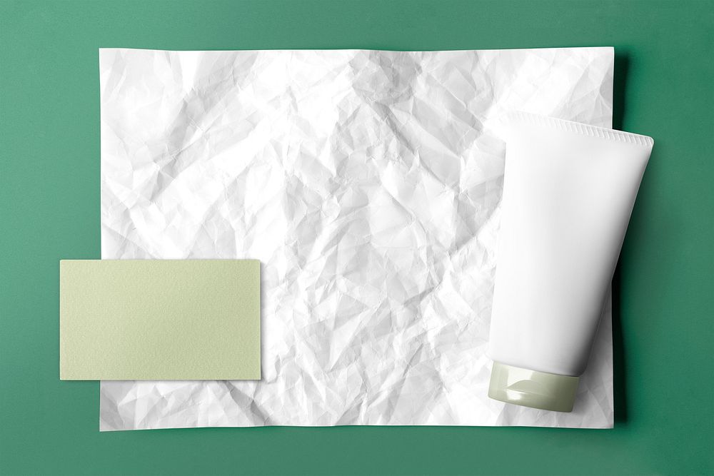 White crinkled paper on green background