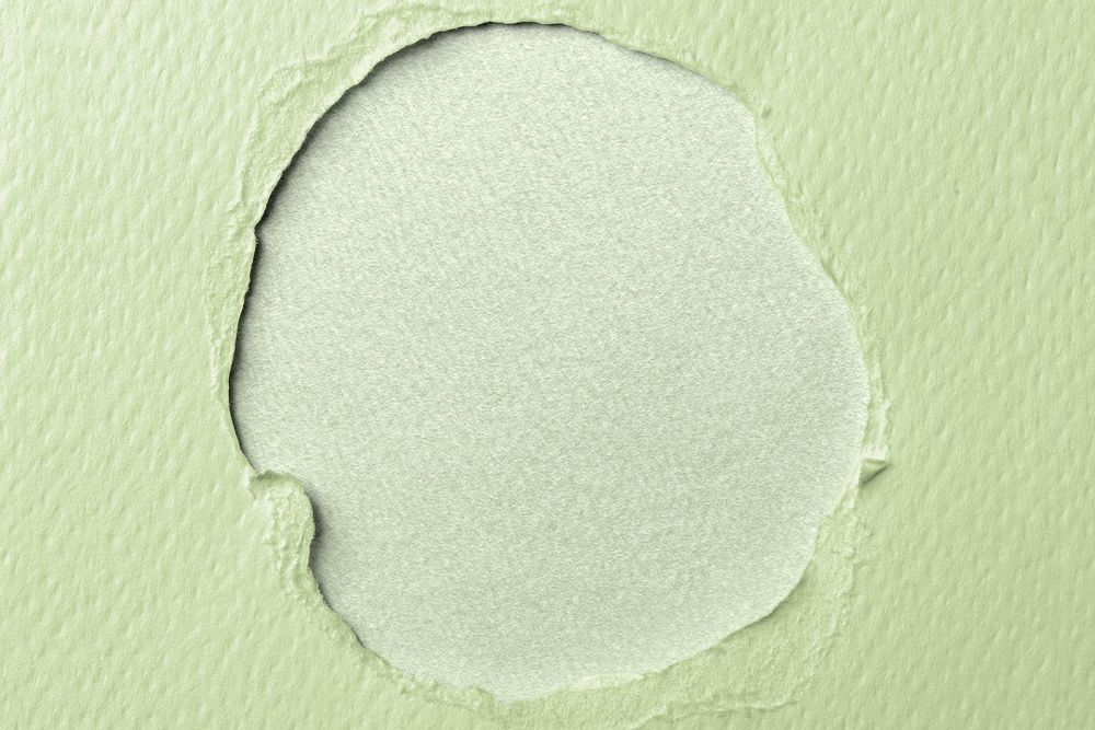 Ripped green paper hole background