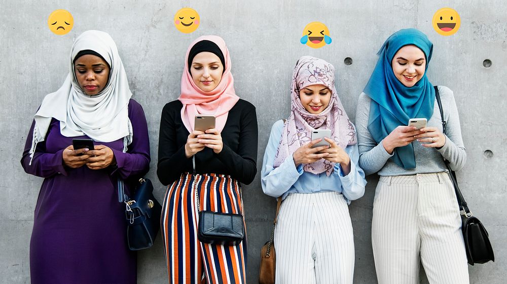 Young Islamic girls playing with their smartphones