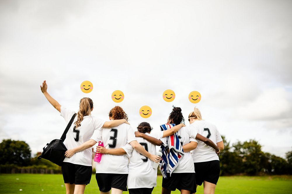 Cheerful female football players huddling