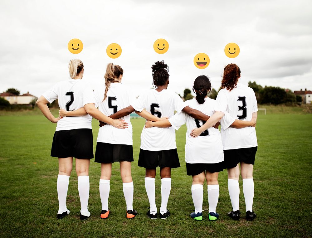 Female soccer players with emoticons standing together