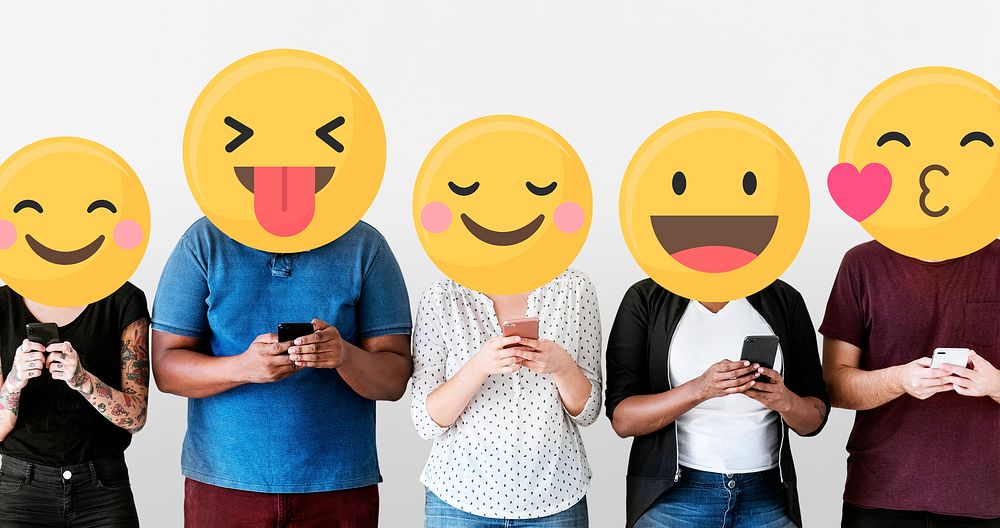 Diverse people with positive emoticons using mobile phones