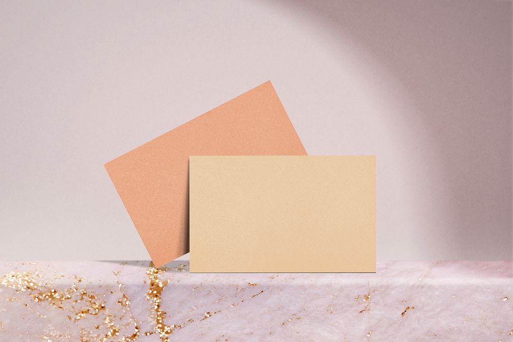 Blank orange cards, business branding, pink marble product backdrop