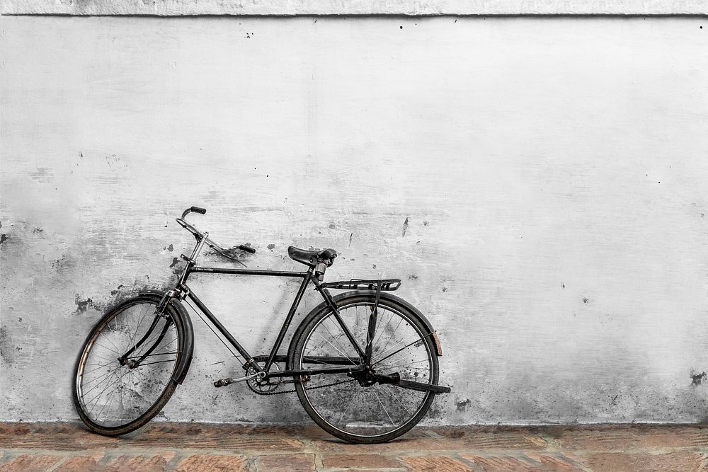 Rustic white wall with bicycle at front