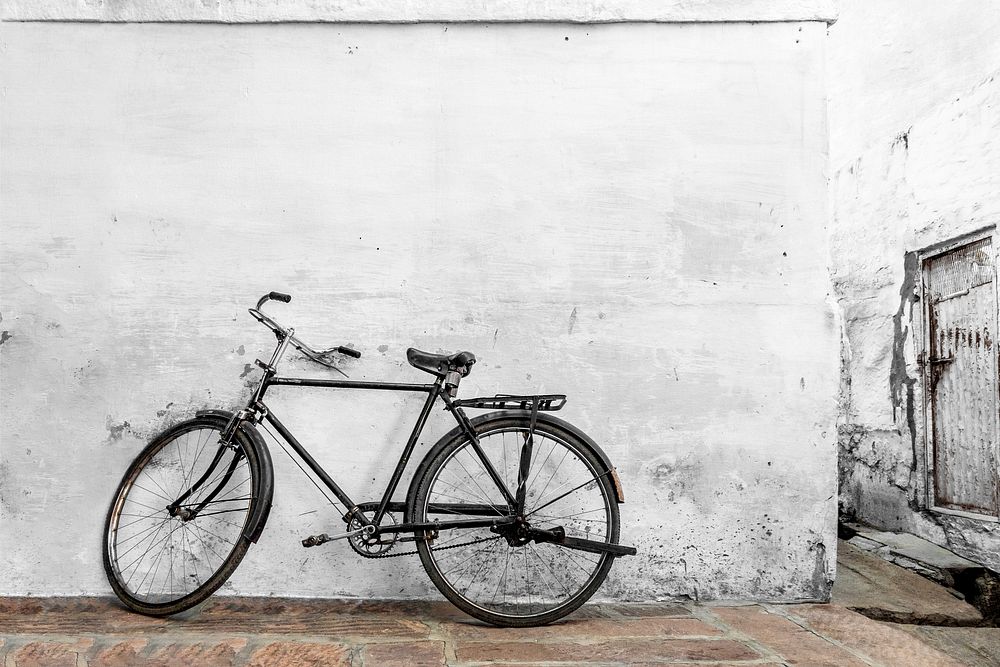 Rustic white wall with bicycle at front