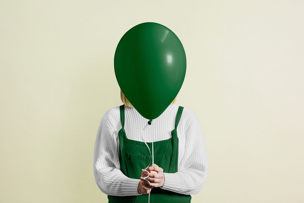 Girl holding St. Patrick&rsquo;s Day balloon 