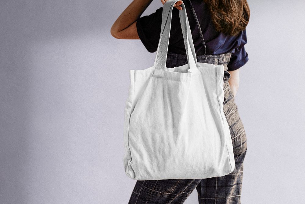 Woman using reusable tote bag, eco-friendly design