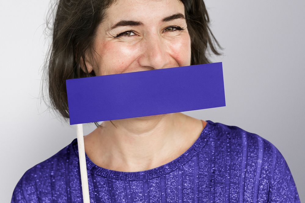 Woman holding purple sign flag with blank space