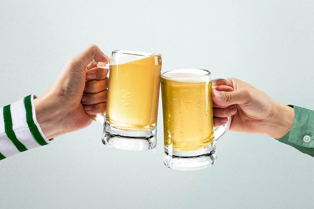 Hands cheering beer mugs, celebrating St. Patrick&rsquo;s Day