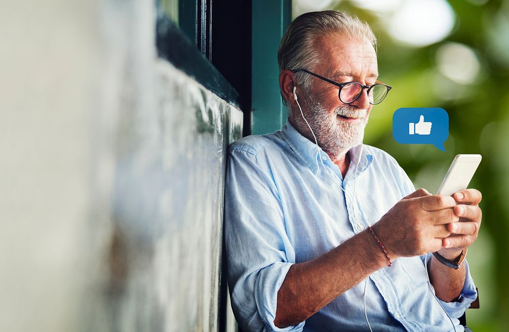 Elderly man texting on his smartphone