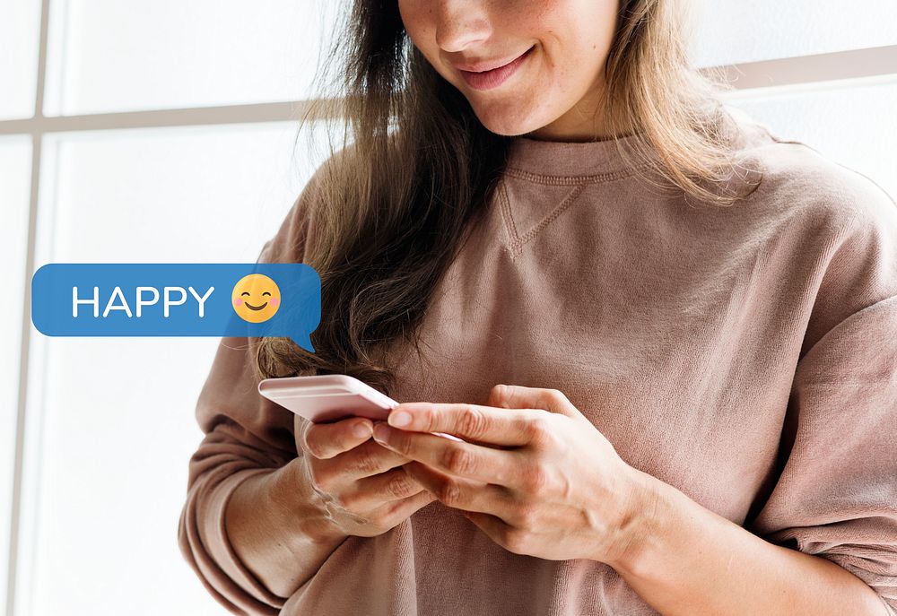 Happy woman using her smartphone