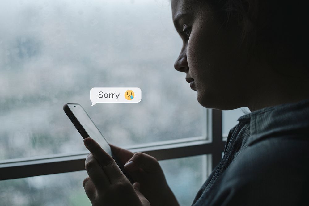 Unhappy teenager texting on her smartphone