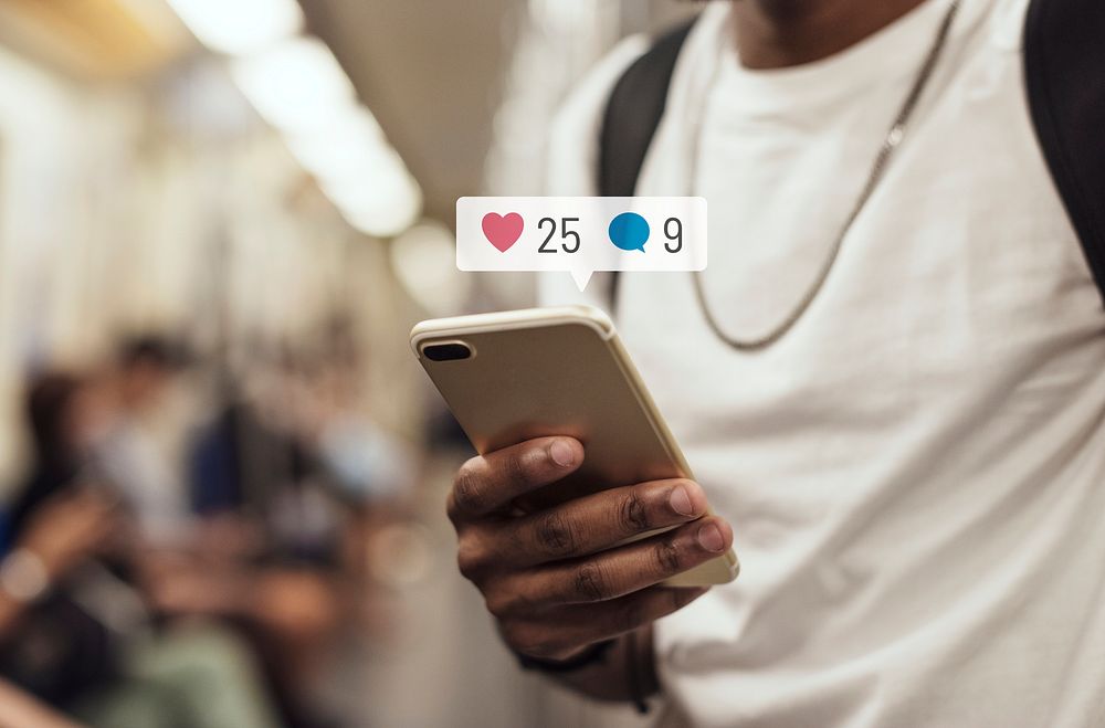 Black man in the subway using social media on his smartphone