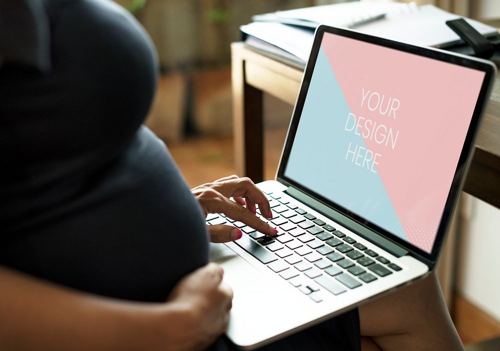 Pregnant woman is using a laptop