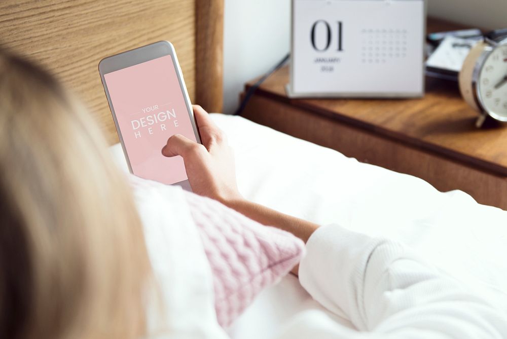 An awake woman checking her phone