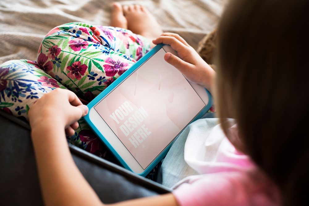 Young girl using a digital tablet with a screen mockup