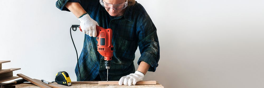 Handyman using a hand drilling machine