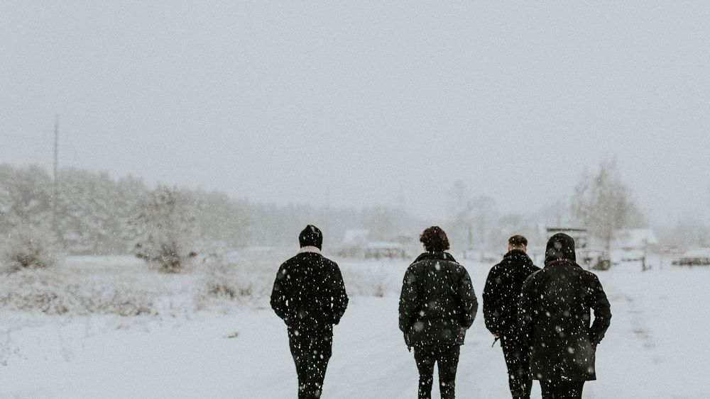 Group of men walking in the snow