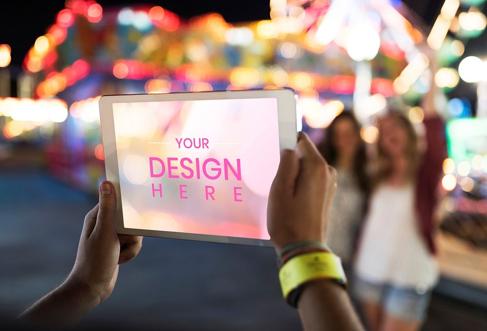Man taking a photo at a carnival with a tablet mockup