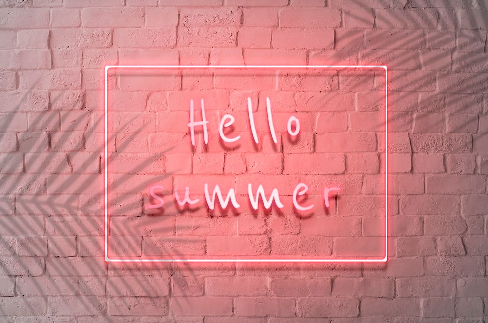 Neon red hello summer sign on a wall