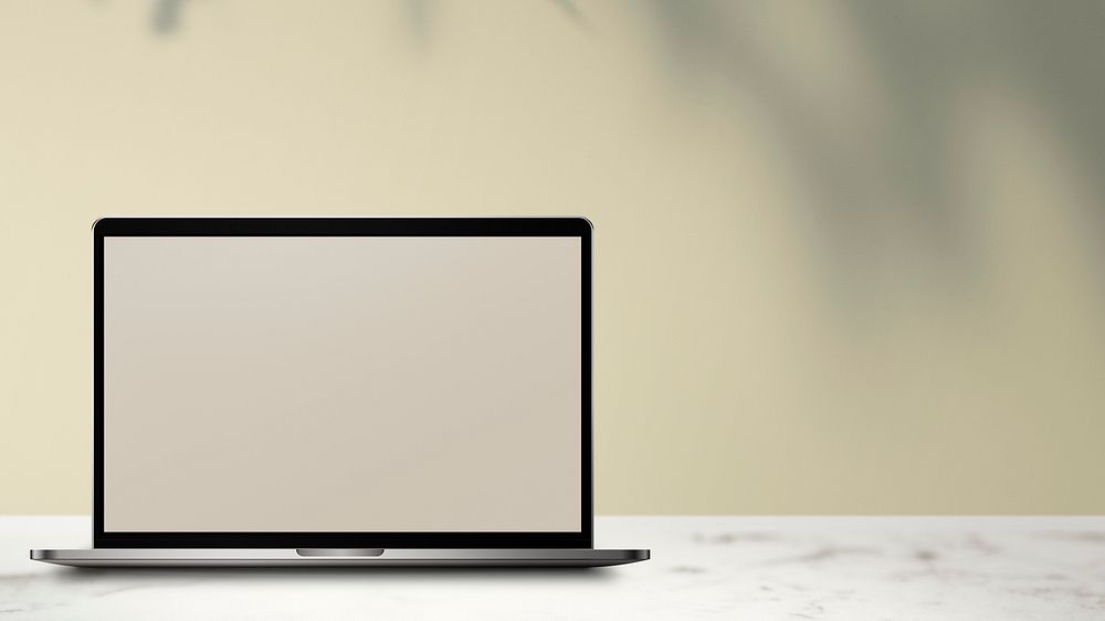 Laptop with screen mockup on a white marble table