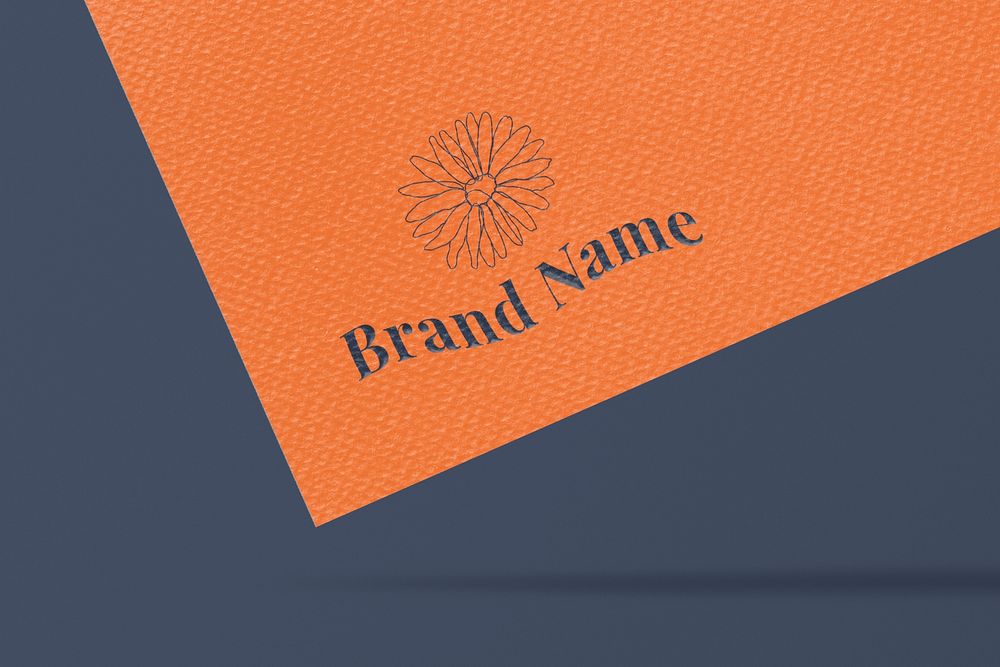 Editable daisy logo mockup psd on orange paper