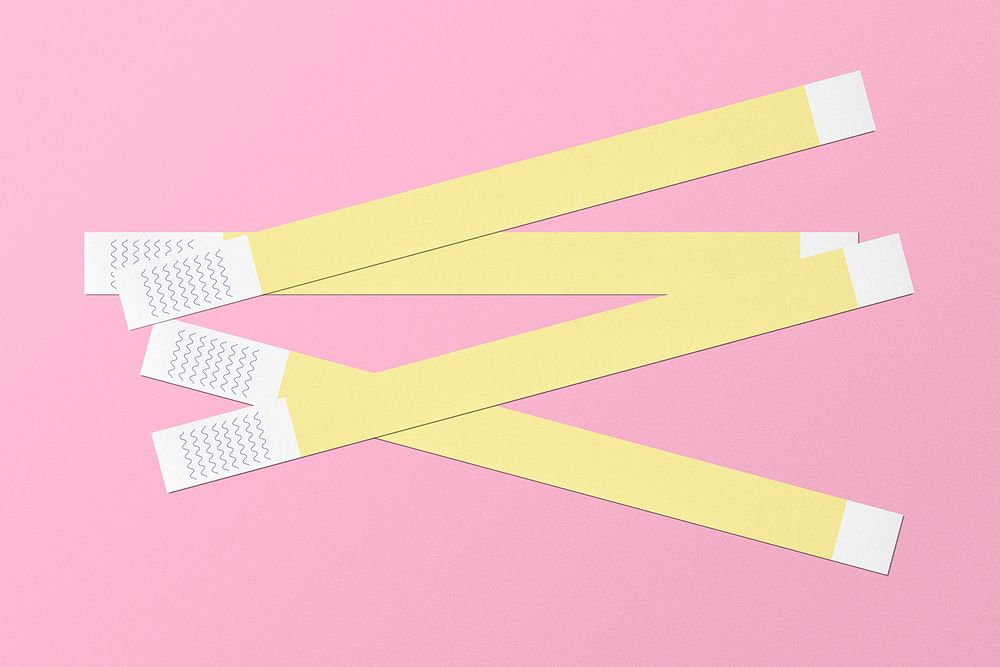 Yellow paper wristbands on pink background