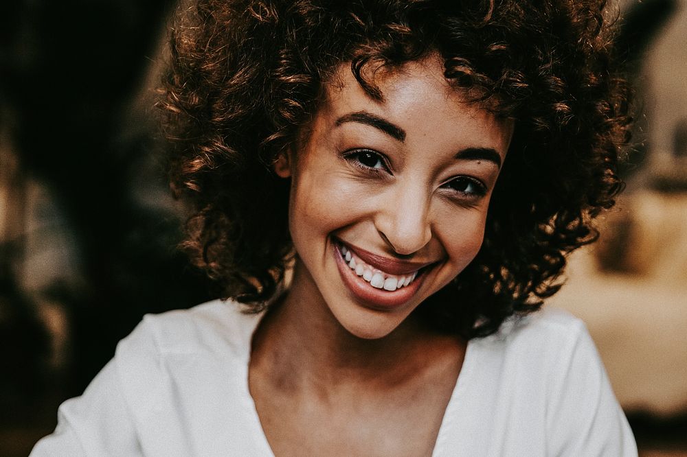 Smiling black woman in white tee portrait