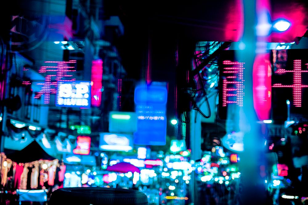 Blurred city night lights, neon shop signs