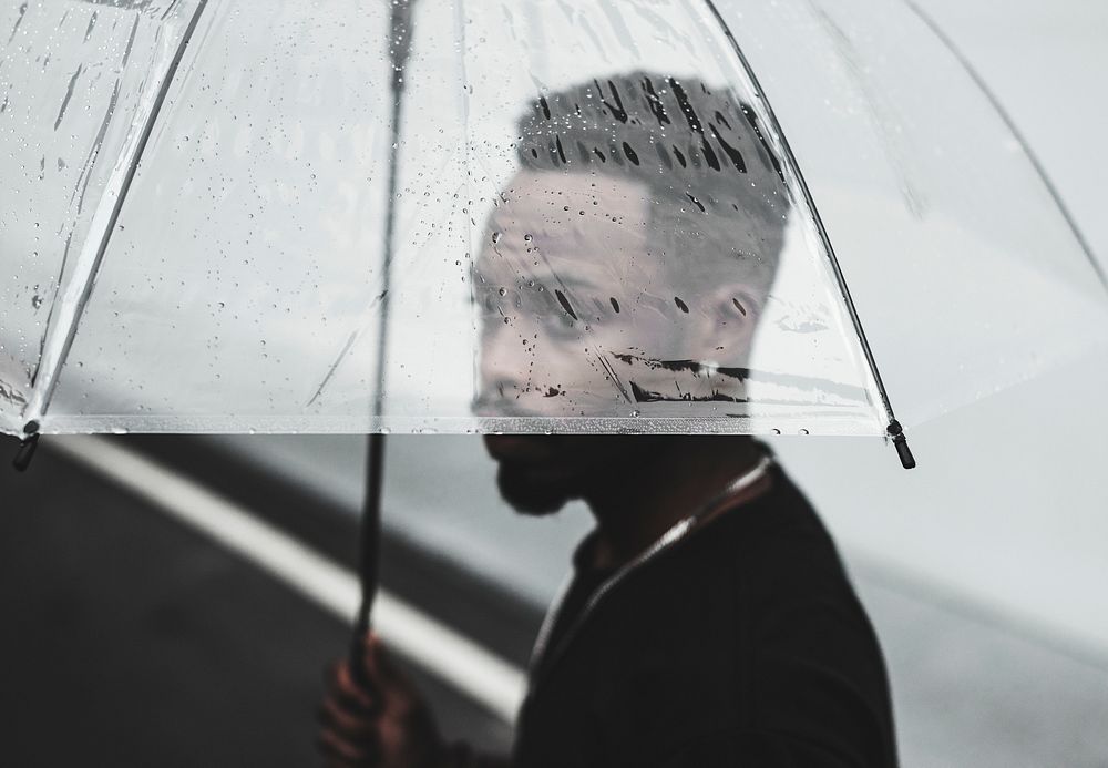 African man using transparent umbrella