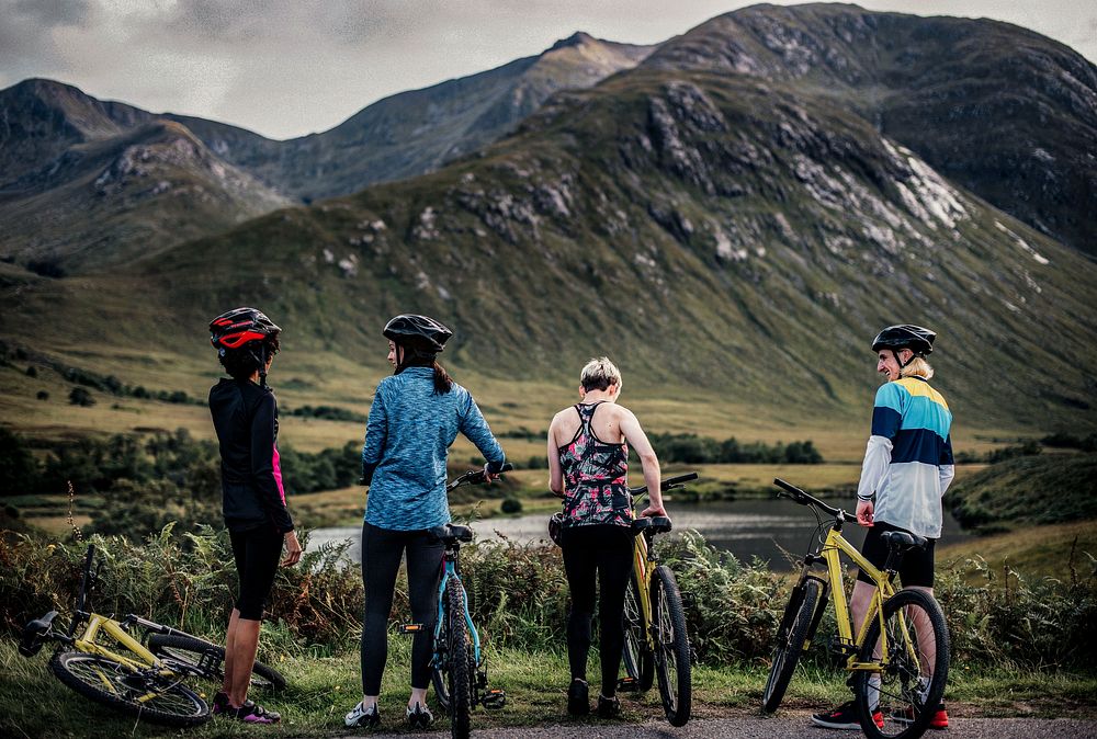 Diverse cyclists by the riverside in the Highlands