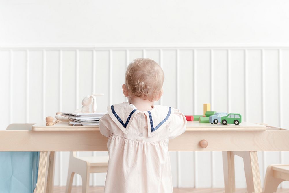 Toddler playing in playroom, rear view