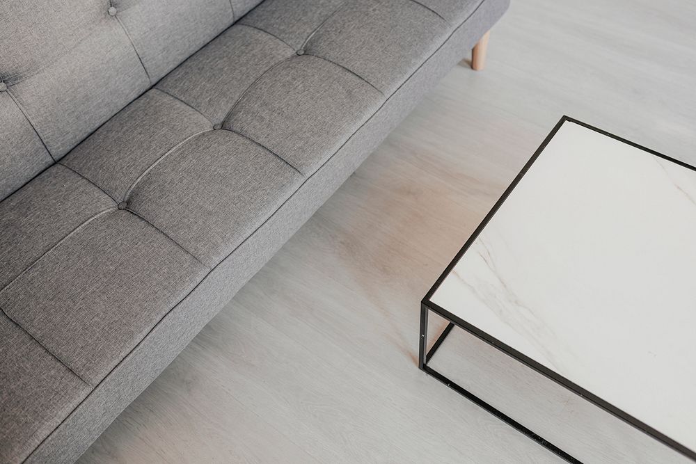 Gray sofa by a marble table