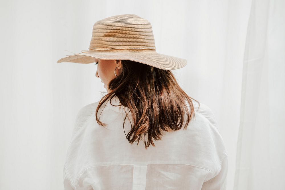 Brown hair woman with woven hat, rear view