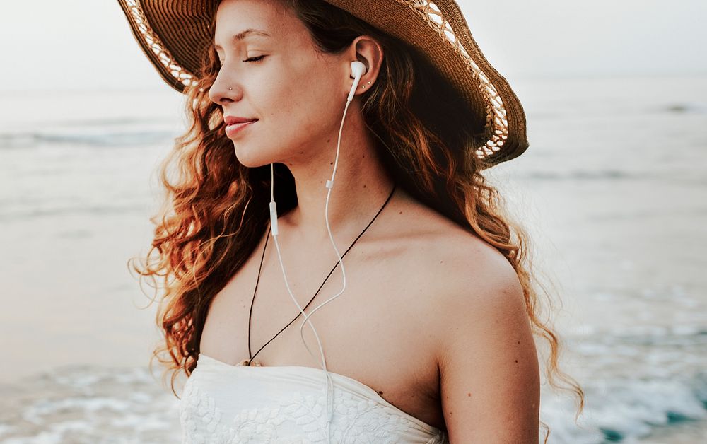 Woman listening to music at a beach