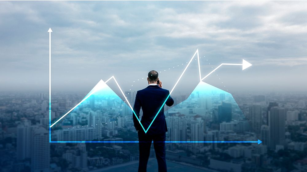 Businessman standing by a positive graph overlooking the city