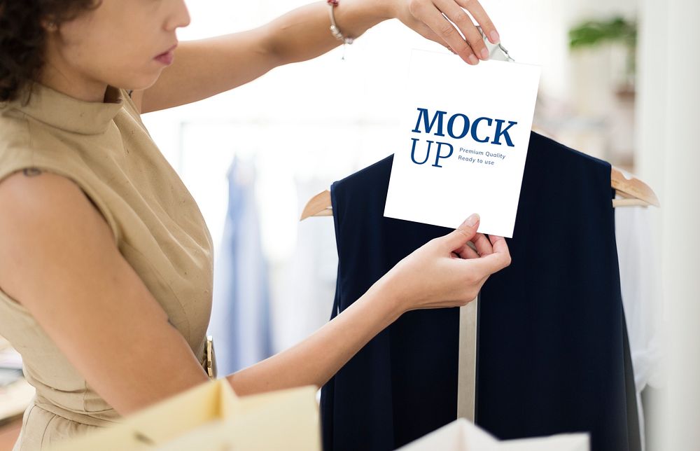 Woman with a plain white sign mockup in a boutique