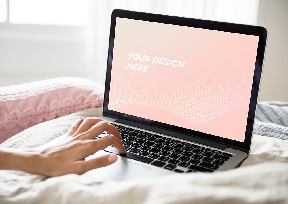 Laptop screen mockup on a bed