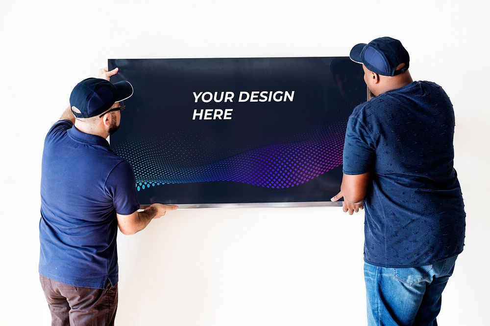 Technician installing a TV mockup on a white wall