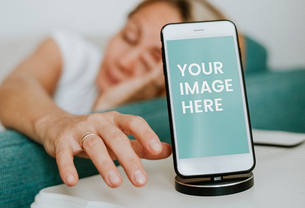 Drowsy woman reaching for a phone mockup