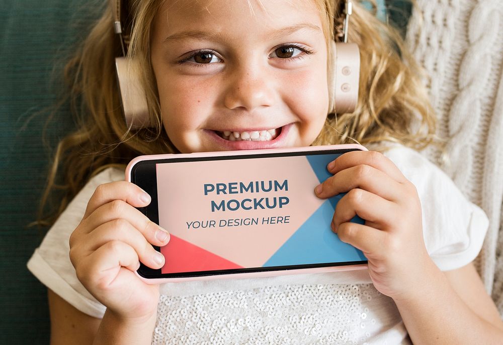 Little girl showing a phone mockup