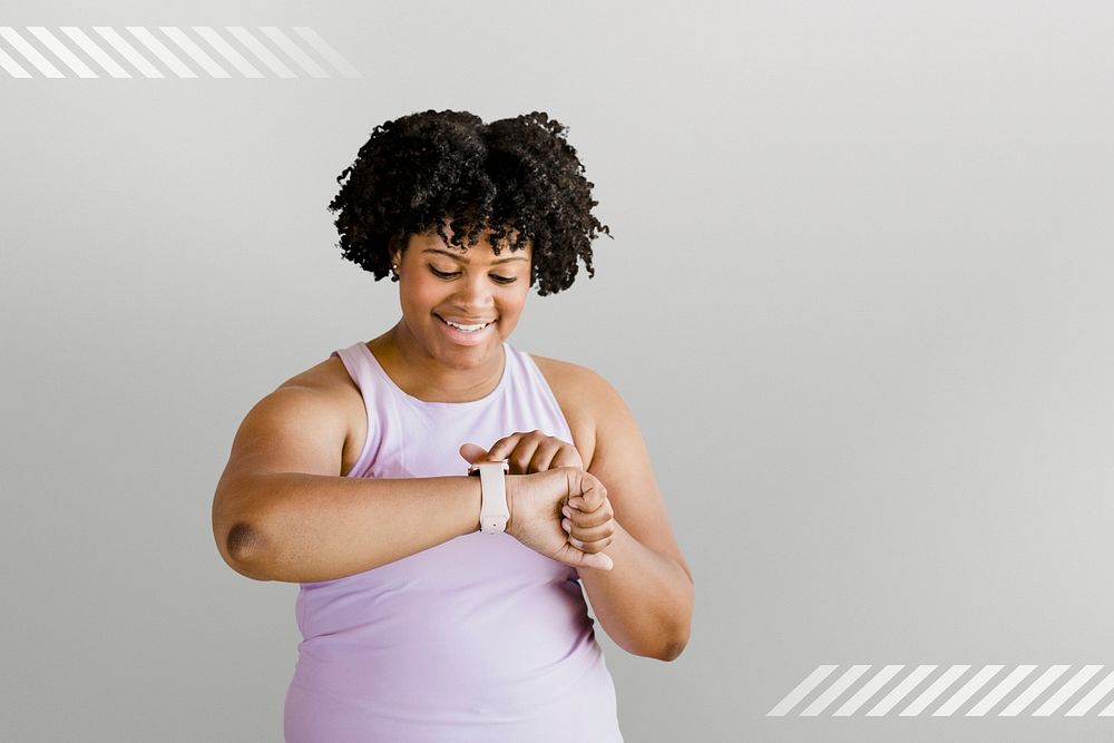 Happy active African American woman using a smartwatch