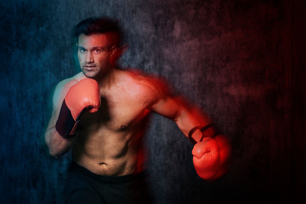 Muscular male boxer with the red boxing gloves