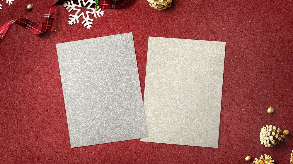 Blank papers mockup with Christmas decorations on red background