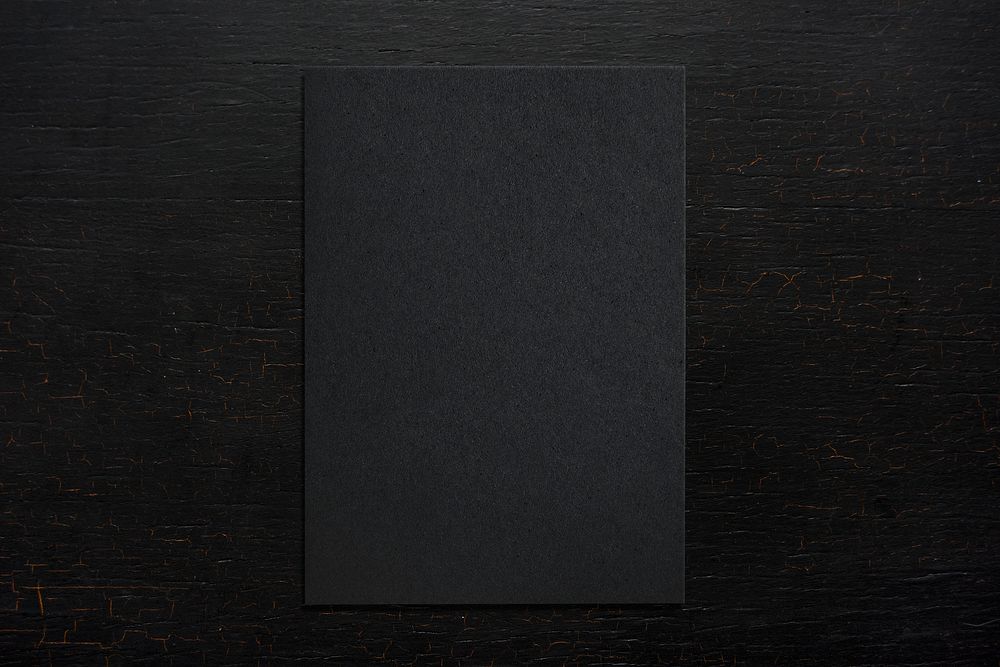 Black paper on a wooden background