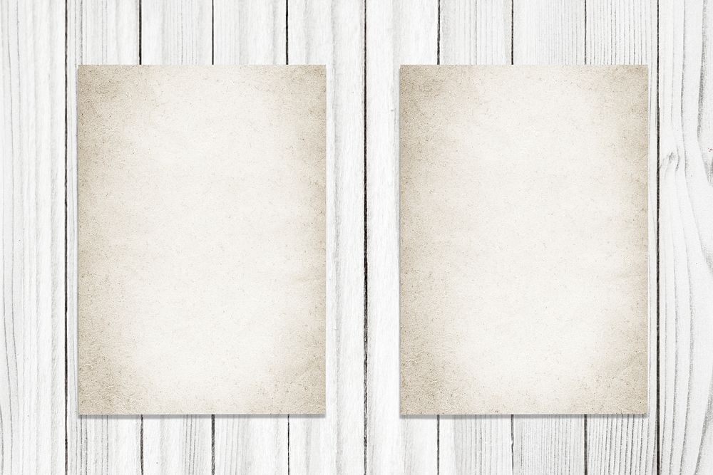 Two vintage papers on a wooden background