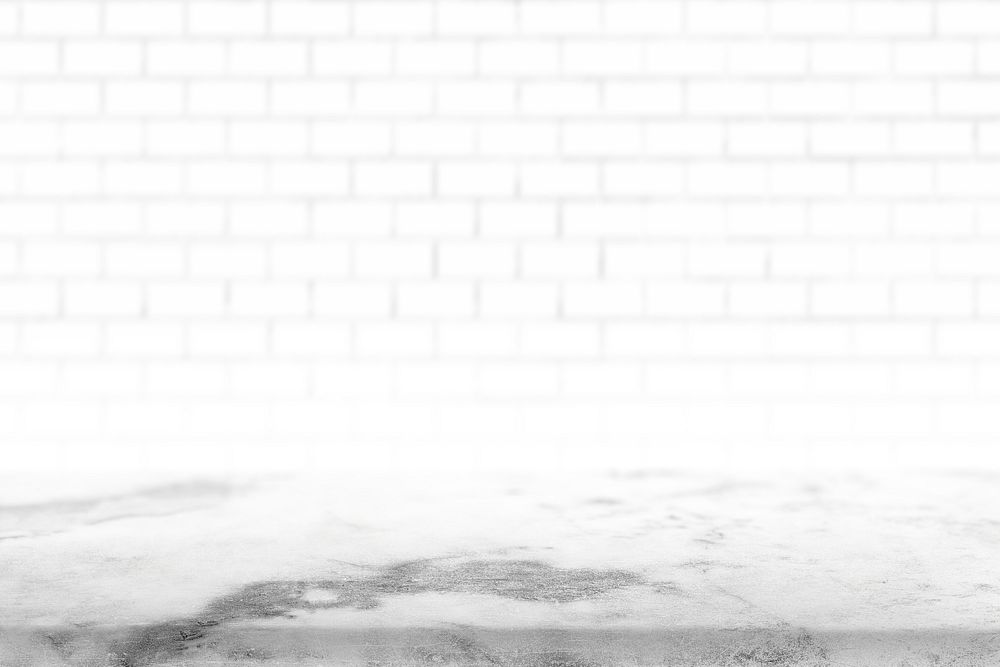 White brick wall with a cement floor
