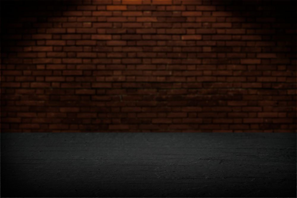 Black wooden plank with brick wall background